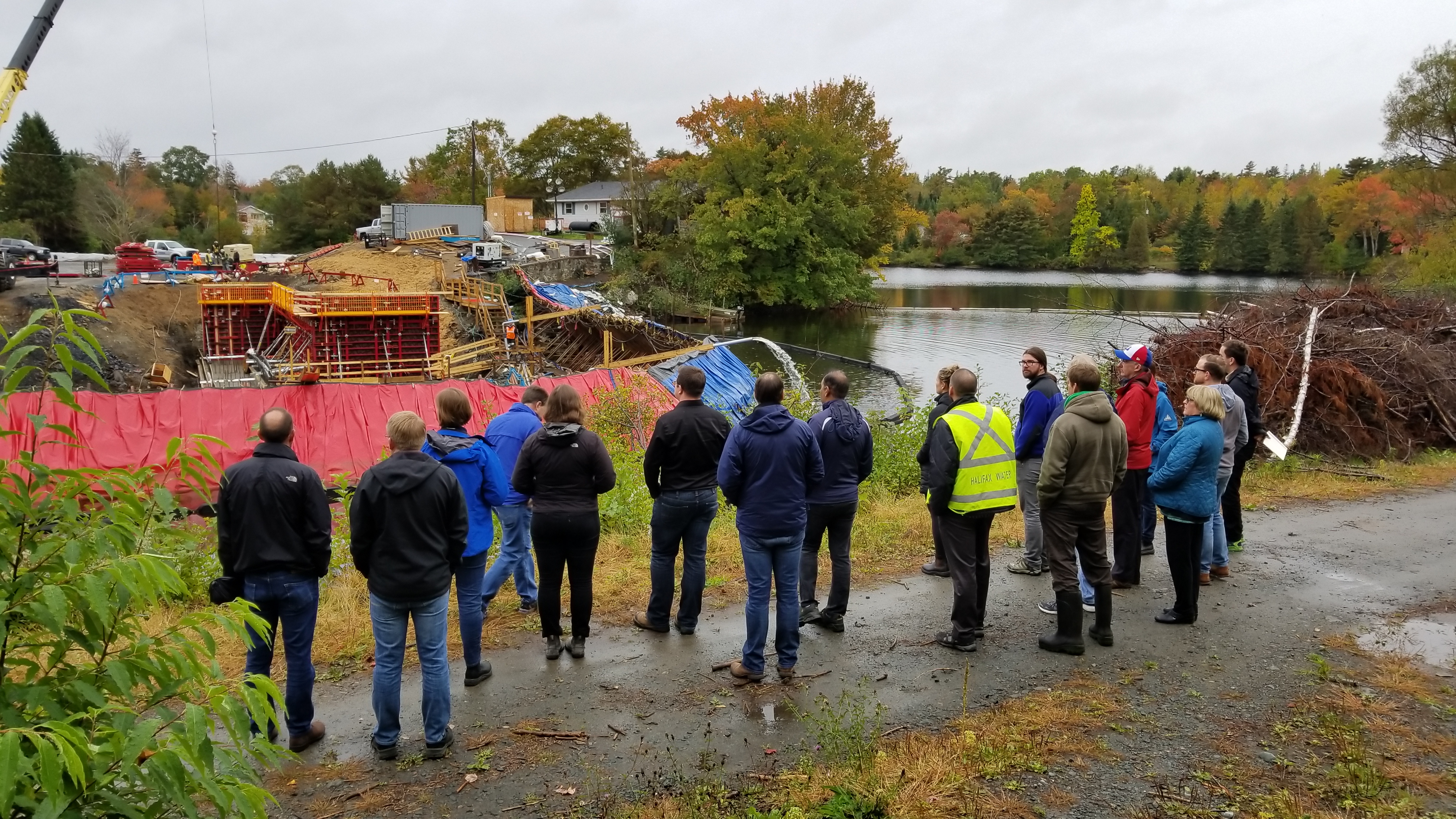 Halifax Water employees and Water Research Foundation employees looking at lake