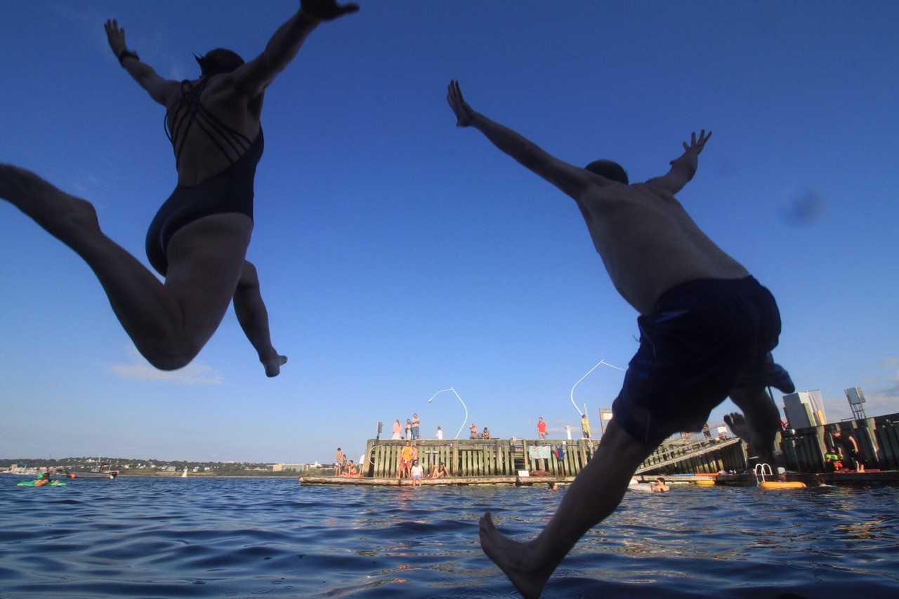 two people jumping into Halifax harbour for a swim