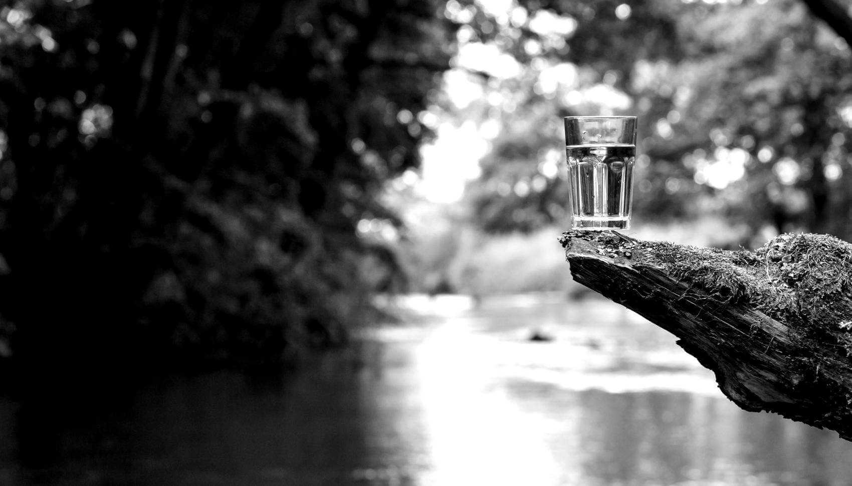 Glass of Water in a Natural Water Source
