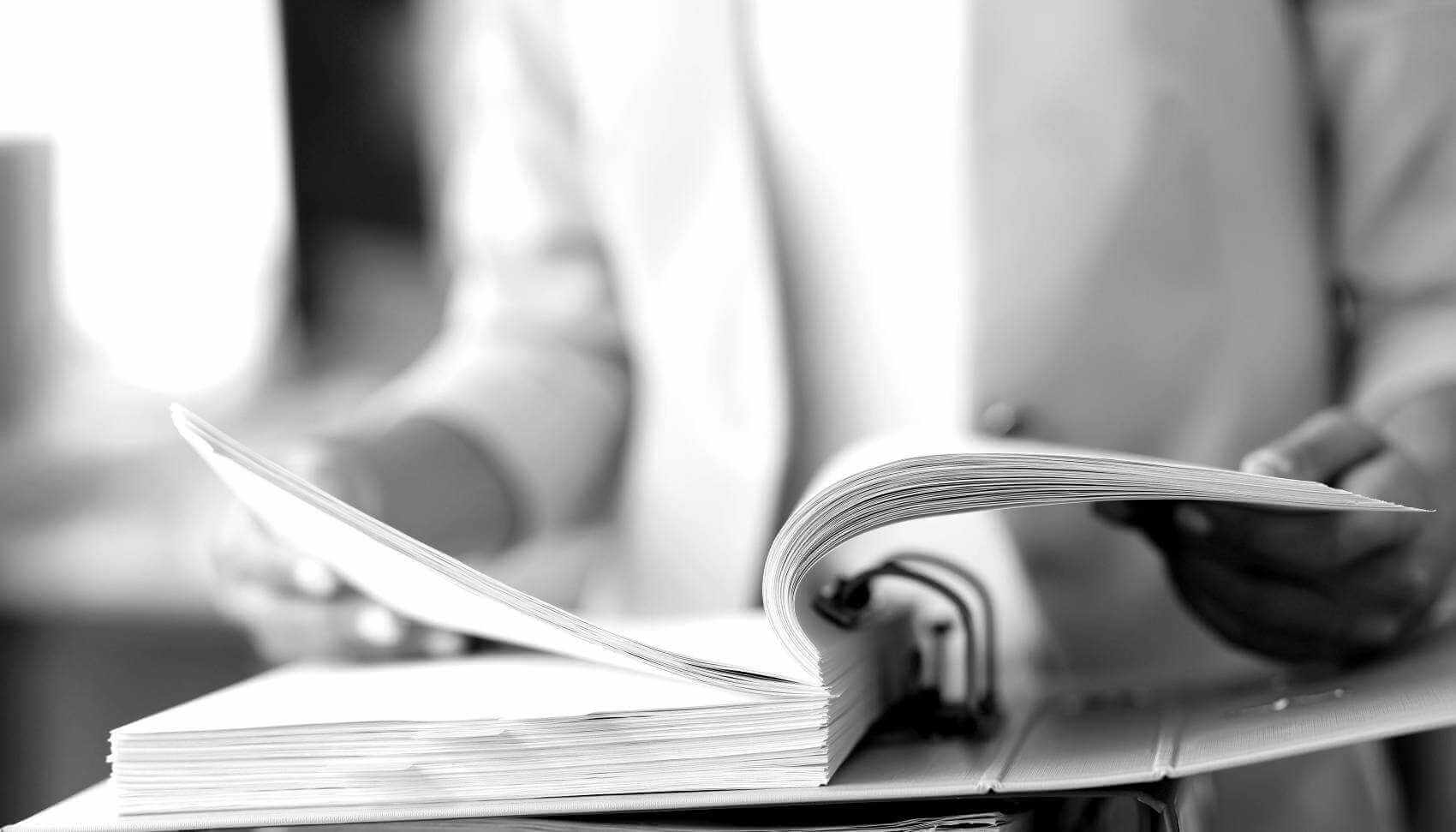 Banner Image - Reguatory Filings &amp; Documents - Woman with Binder - AdobeStock_444398005