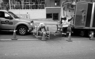 Workers and trucks getting ready for work on a manhols