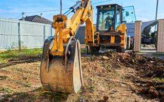 Banner Image - Get the Lead Out - Excavator Digging a Service - AdobeStock_384691445
