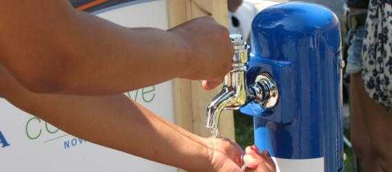 a portable Halifax Water tap being used to wash hands